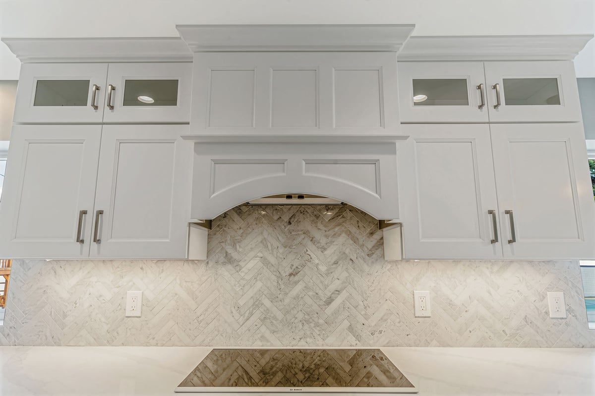 Kuhn Construction kitchen remodel in Massapequa, New York featuring detailed white cabinets and mosaic backsplash