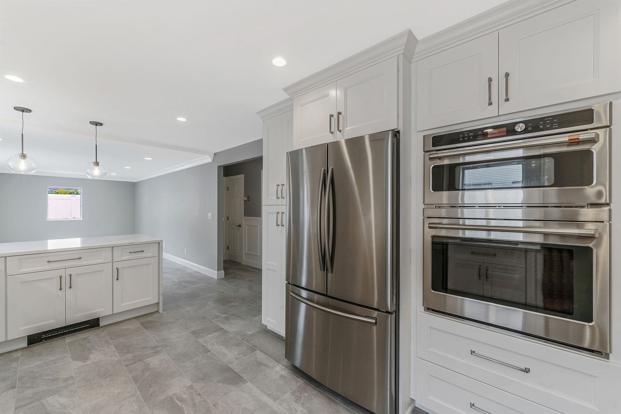 Kuhn Construction kitchen renovation in Massapequa, NY featuring white cabinets and stainless steel appliances