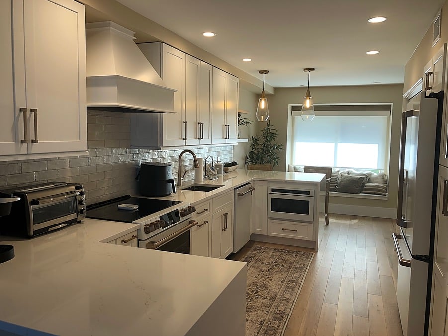 upgraded white kitchen with light floors