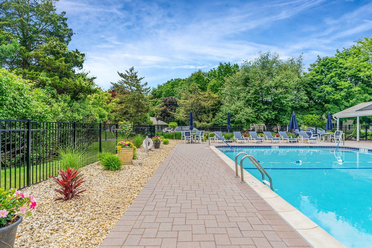 New fencing and gates around pool in condo complex poolhouse remodel in Islip, NY by Kuhn Construction