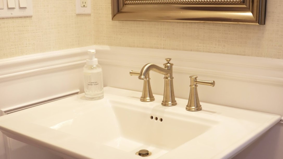 Pedestal sink with nickel faucet fixture in Islip, NY bathroom remodel by Kuhn Construction