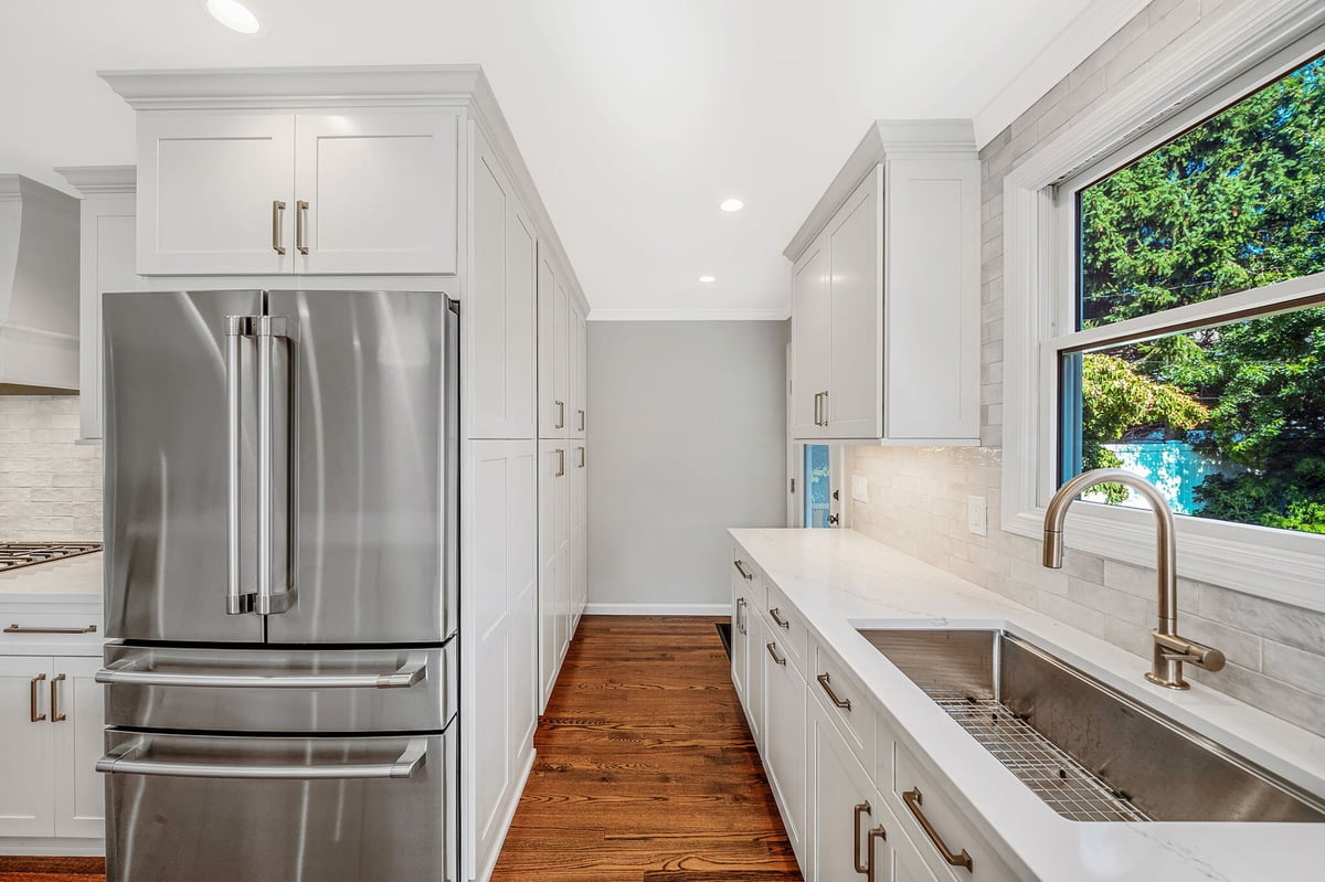 Kitchen remodel with stainless steel appliances and oak flooring by Kuhn Construction in Hicksville, NY