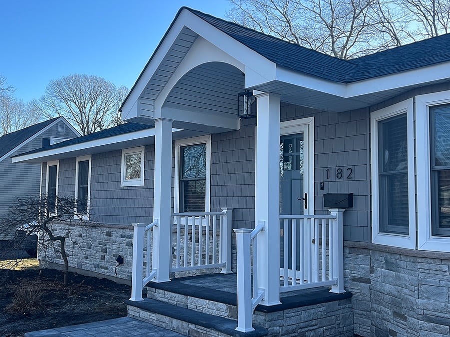 Portico addition in Patchogue, NY home exterior with white columns and vinyl railings by Kuhn Construction