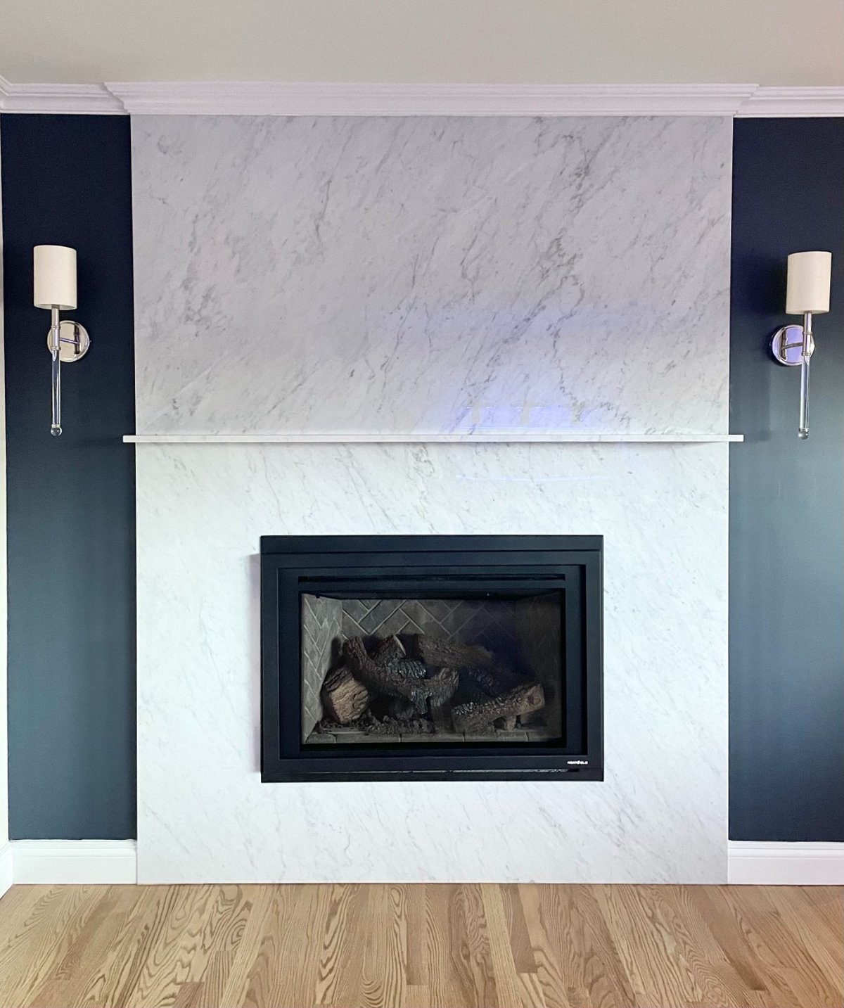 Modern fireplace with stone surround in Islip, NY first floor remodel by Kuhn Construction