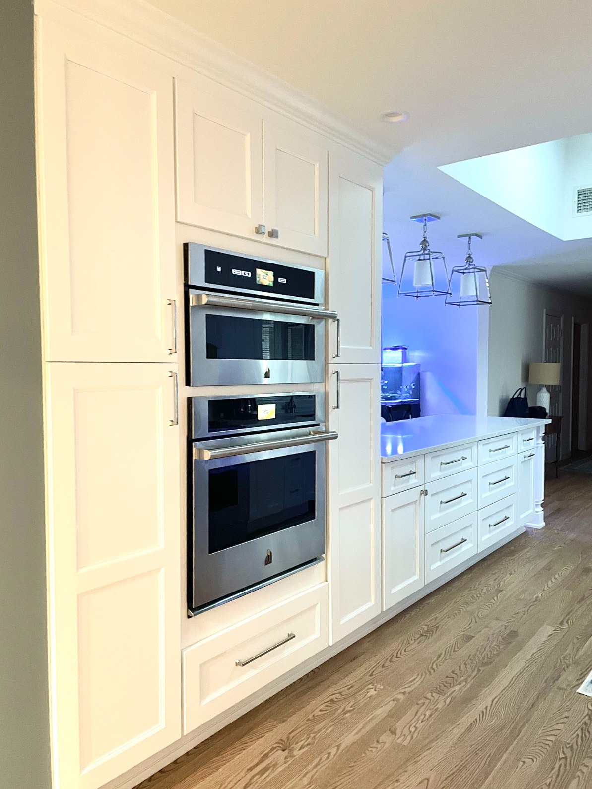 White shaker cabinets around double oven in Islip, NY kitchen remodel by Kuhn Construction