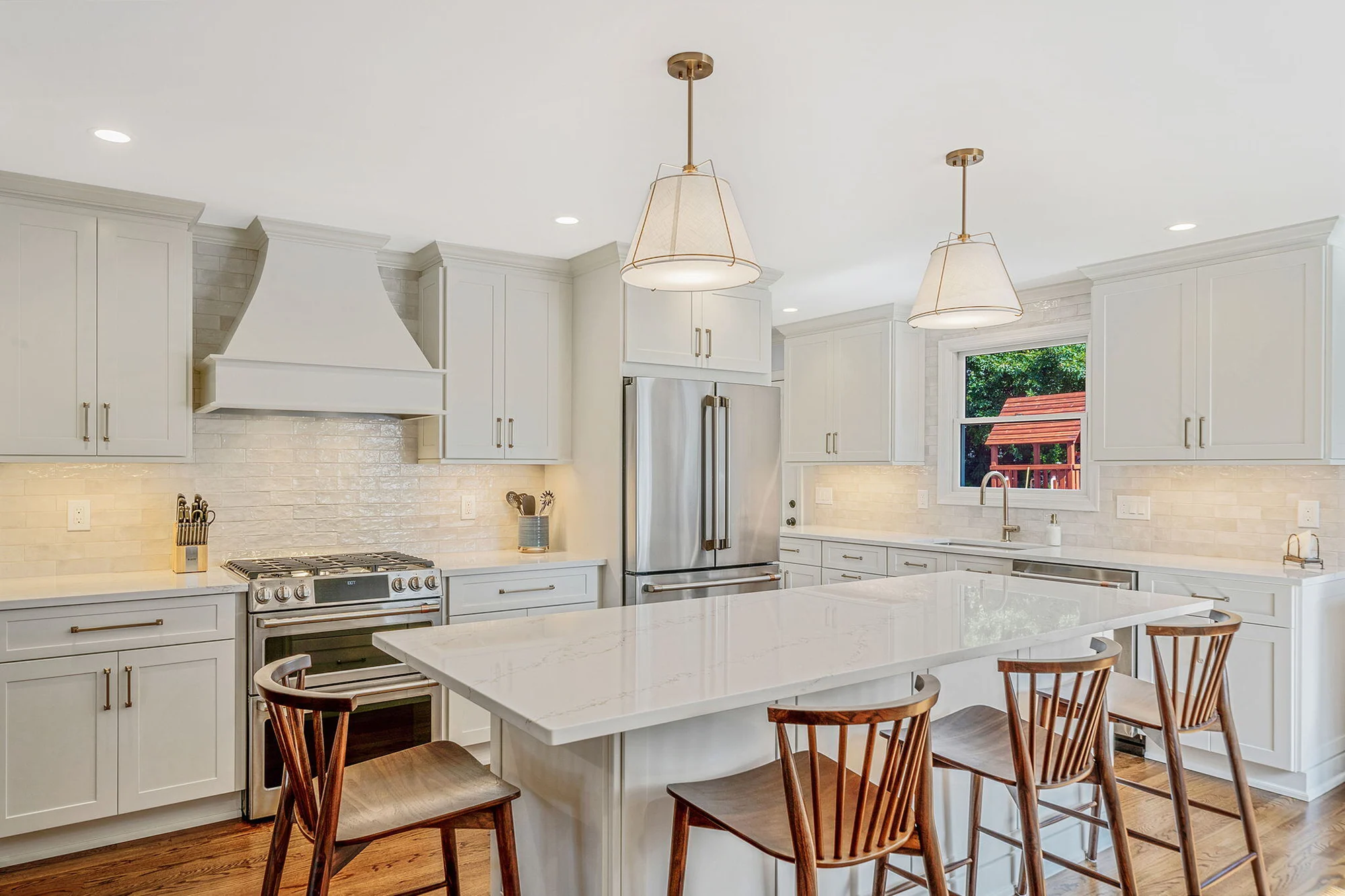 Custom kitchen remodel featuring an island, Fabuwood cabinetry, and oak floors in Hicksville, NY by Kuhn Construction