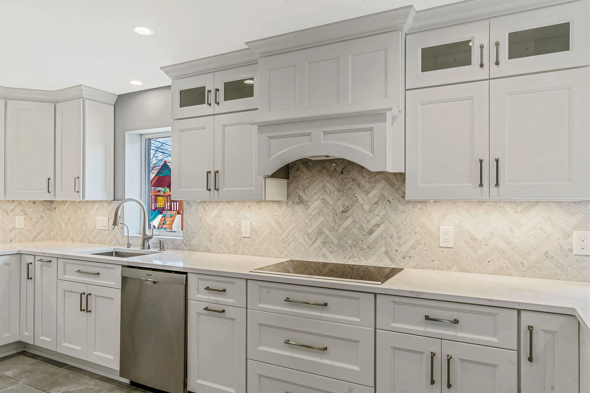 Kitchen remodel by Kuhn Construction with Fabuwood cabinets and mosaic backsplash