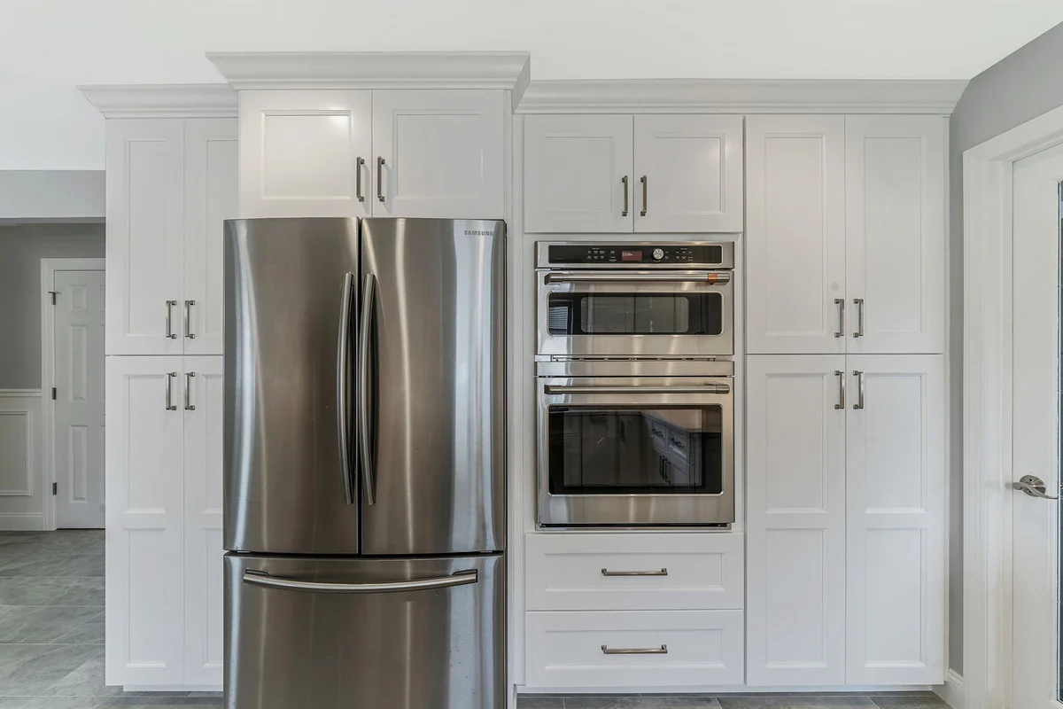 Kuhn Construction kitchen remodel in Massapequa, NY featuring white cabinets and stainless steel appliances