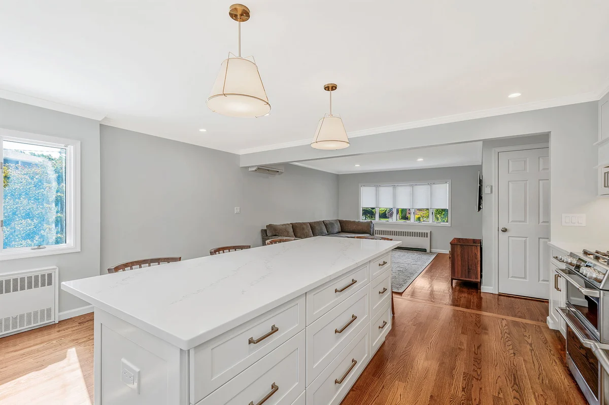 Large island with storage in kitchen remodel by Kuhn Construction in Hicksville, New York