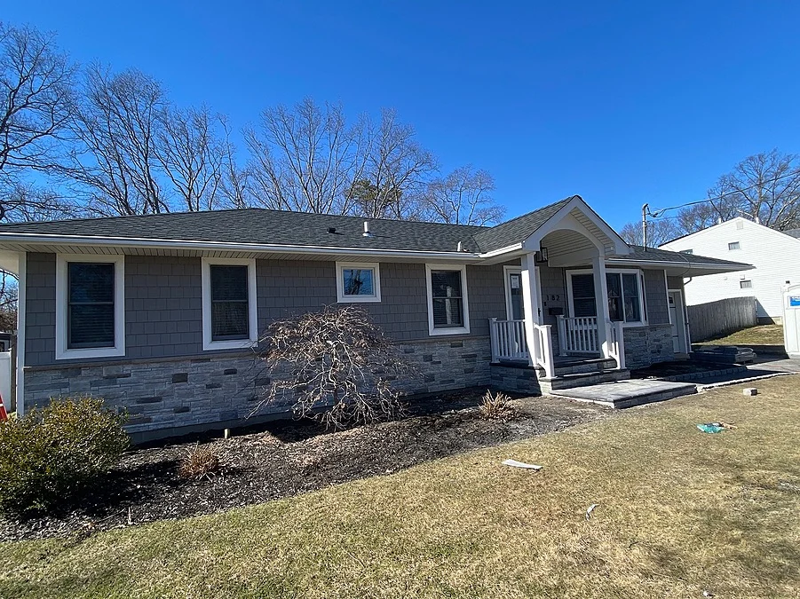 Portico addition and exterior home remodel in Patchogue, New York by Kuhn Construction