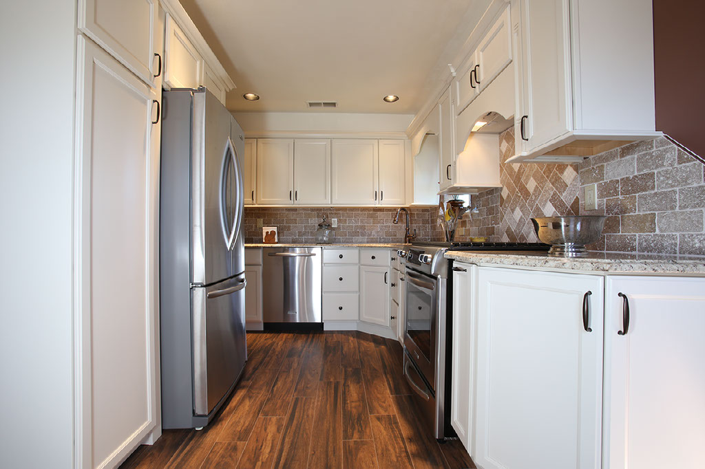 small upgraded kitchen with white cabinets