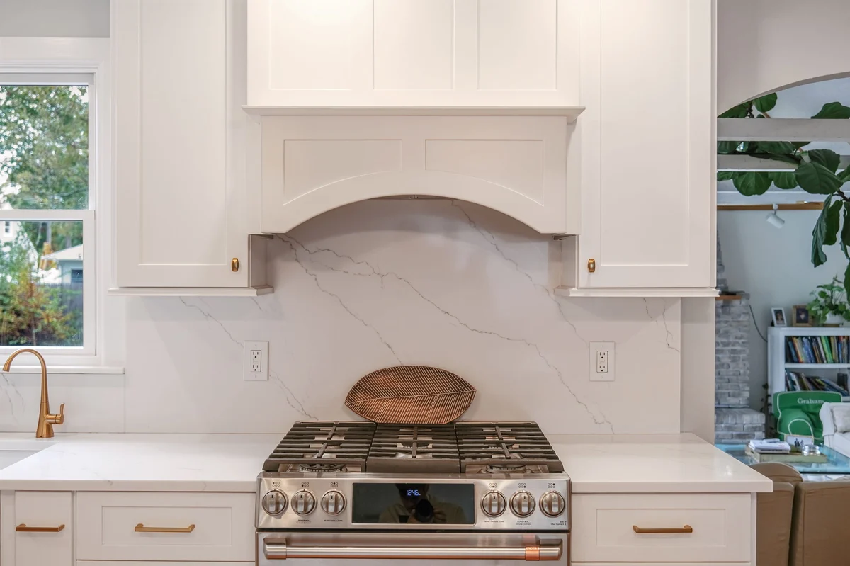 sleek gas stove with white hood